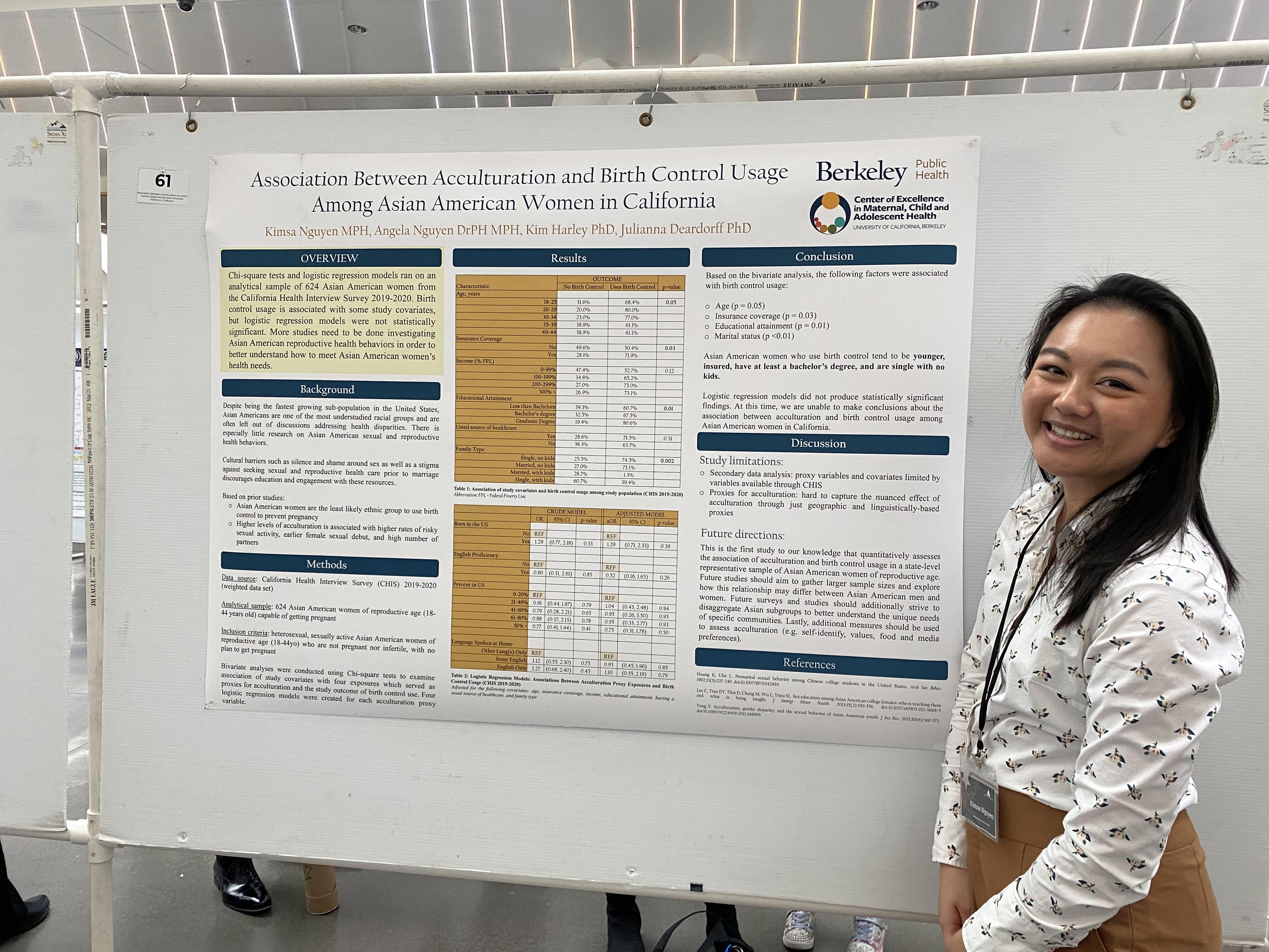 Kimsa posing to the right of her presentation poster