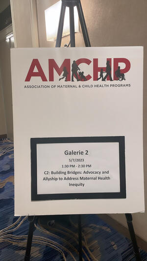 Poster board that reads "AMCHP" in red block letters at the top followed by "Association of Maternal and Child Health Programs"
