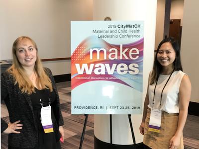 Two MCAH students standing next to the poster in a 2019 MCH Leadership Conference in Rhode Island 