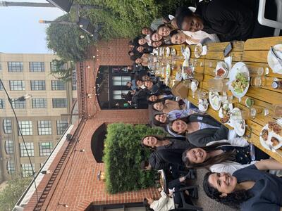 UC Berkeley and UW students, staff and faculty around a large dinner table at a restaurant