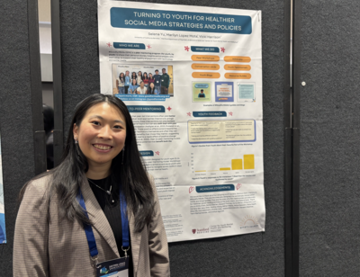 Selena Yu (MCAH MPH '25) standing next to her poster presentation titled "Turning to youth for healthier social media strategies and policies," focusing on uplifting youth voices and centering their lived experiences.